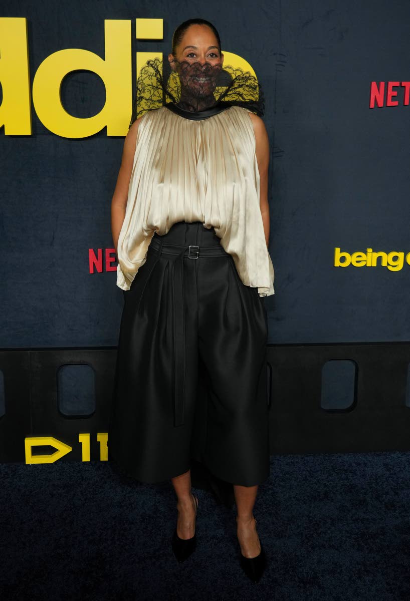 Tracee Ellis Ross wears a sleeveless silk blouse with a lacy statement neckline and wide-leg capri trousers by Dior. 
