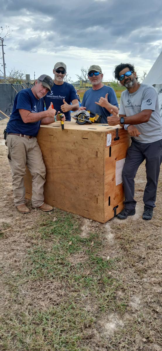From left: Michael Stanard (volunteer), Luke Thomas (Samaritan’s Purse staff), Charlie Geer (volunteer) and Ricky Geigel (volunteer) are setting up a ‘sewerage’ at the Black River field hospital established at Black River High School.