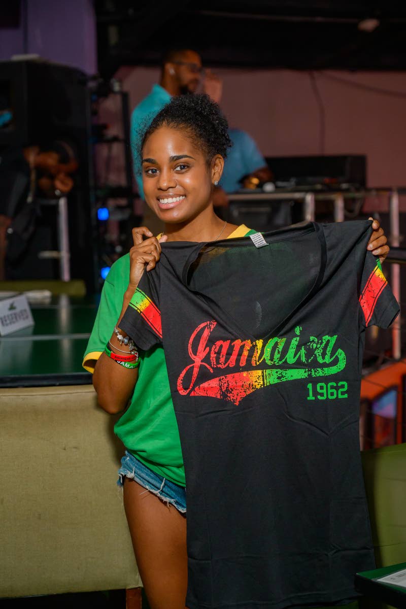 Crystal Davis, daughter of Beenie Man and Carlene Smith, beams with pride after snagging a Jamaica T-shirt prize ahead of the Reggae Boyz game.