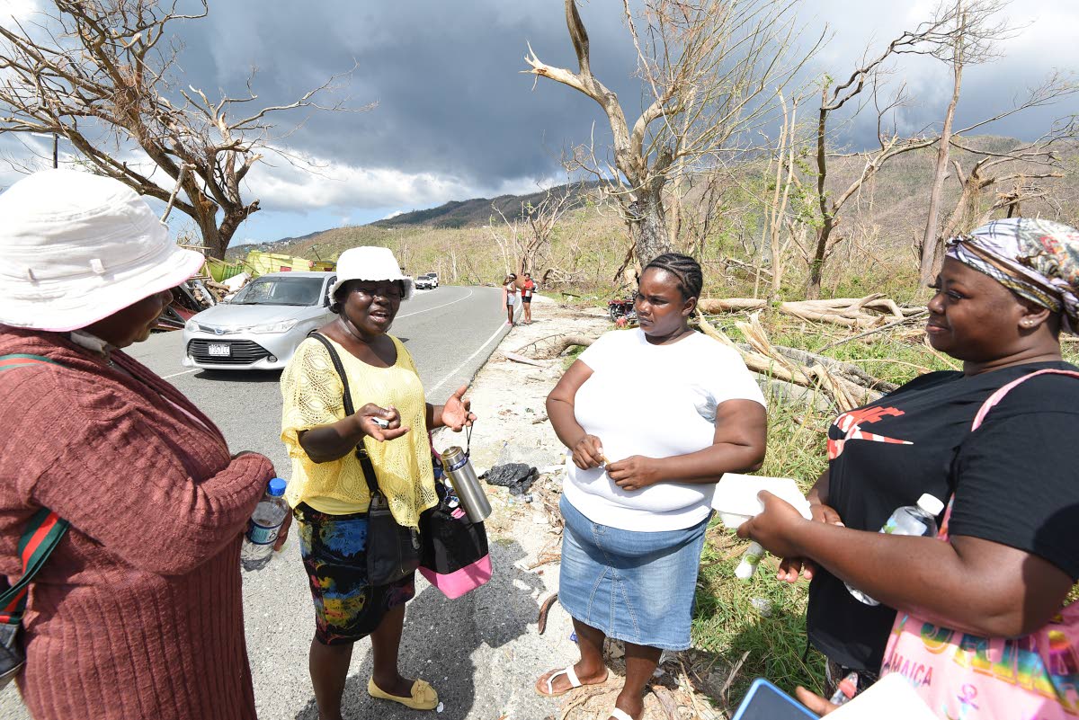 
Marcia Clarke (left), Donna Moodie (second left), Carolyn Finlayson (second right), and Maverna Ricketts (right) of Retirement, Bluefields, Westmoreland, describe the impact of Hurricane Melissa on their homes and community.