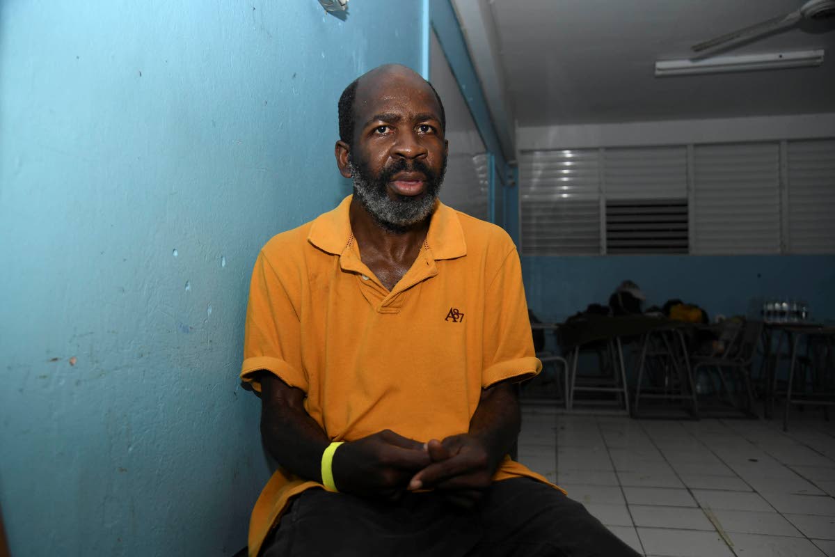 
Chevron Campbell sits quietly in the shelter, his hands trembling involuntarily from Parkinson’s disease.