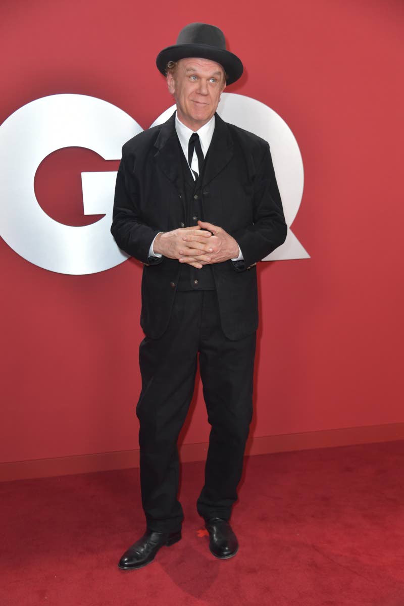 John C. Reilly goes old-school cool in a black bowler hat, ribbon tie, and vintage-inspired suit.