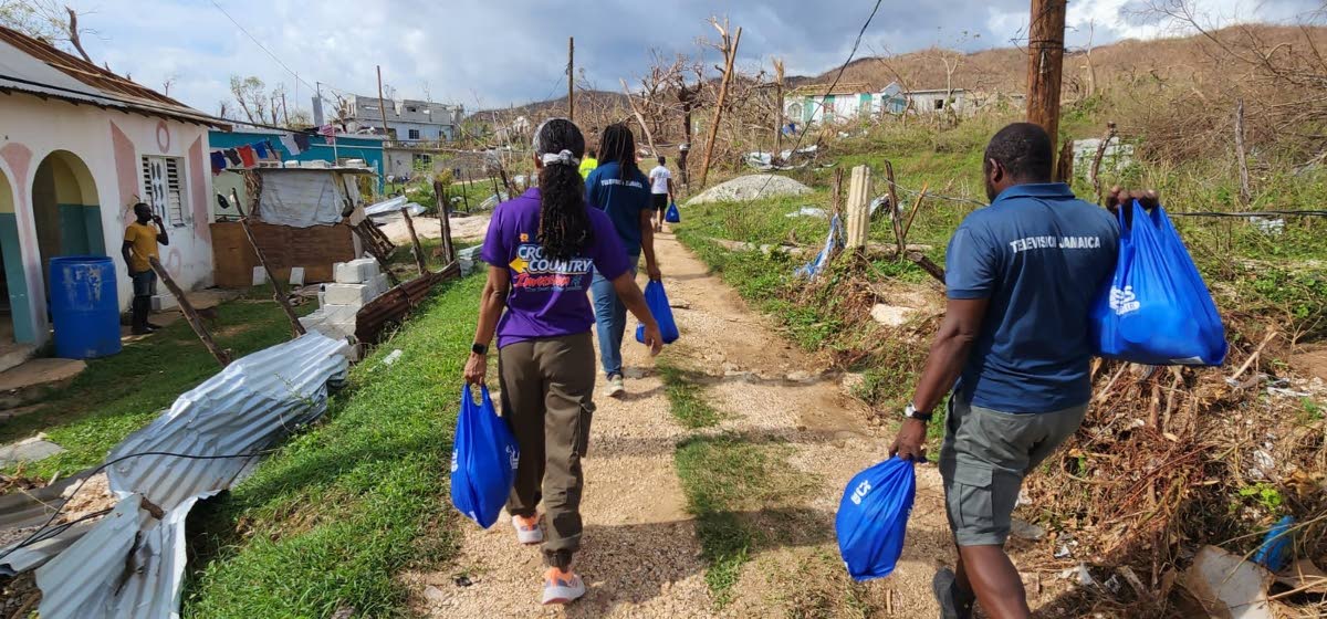 RG CARES volunteers make their way on foot, off Brompton Lane in St Elizabeth,  into hard-to-reach and hillside communities, ensuring that residents in the most isolated areas receive relief.