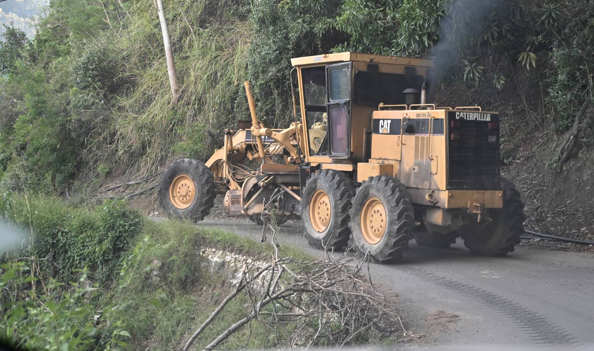 A tractor working on clearing the Mavis bank road.