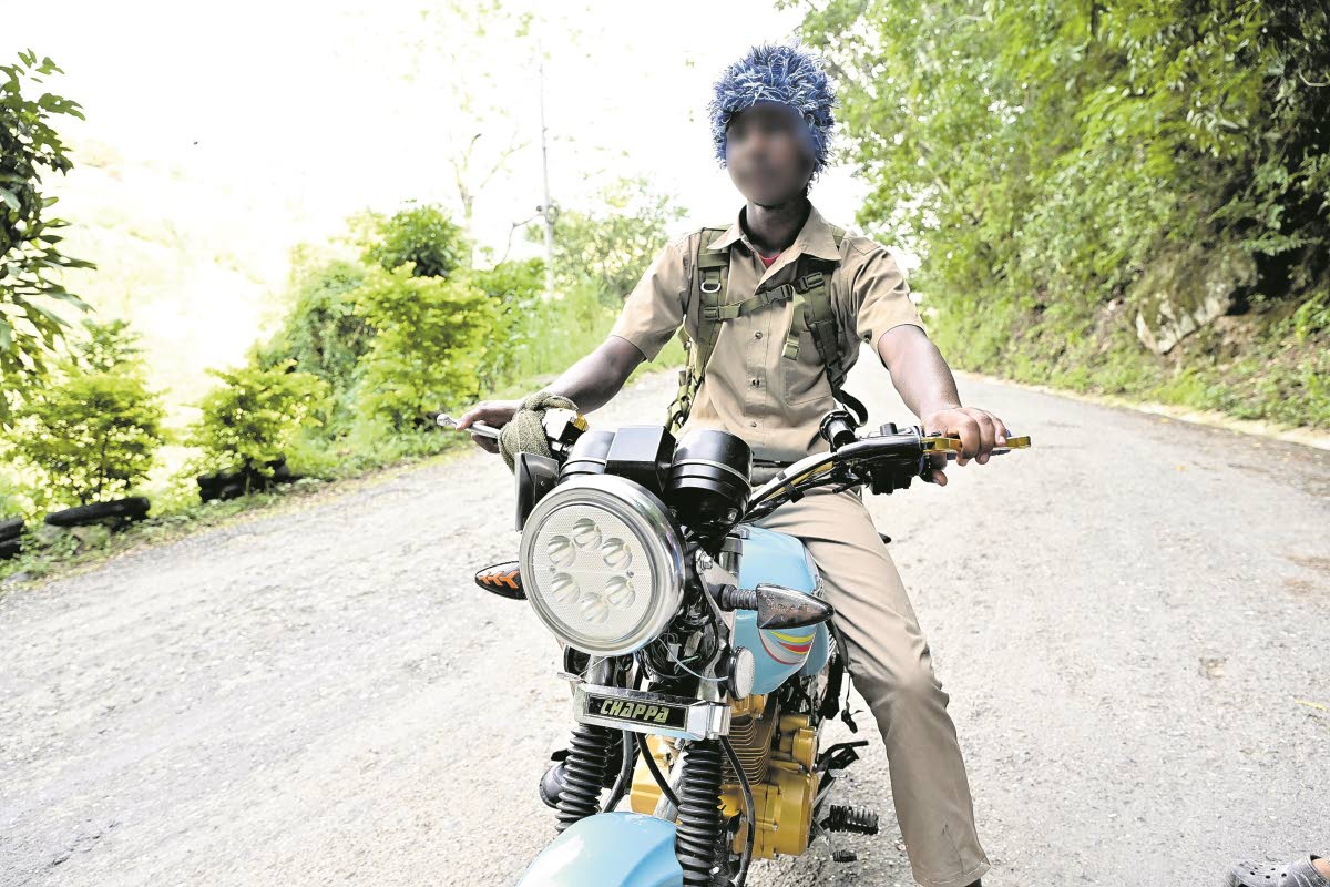A sudent of Mavis Bank High School in St Andrew journeys home on his motorbike after school last week.