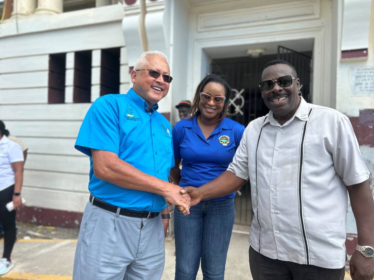 Justice and Constitutional Affairs Minister Delroy Chuck (left) shakes hands with Westmoreland Custos Reverend Hartley Perrin after touring the Westmoreland Parish Court in Savanna-la-Mar on Friday. Looking on is Kadeish Jarrett-Fletcher, director of clien