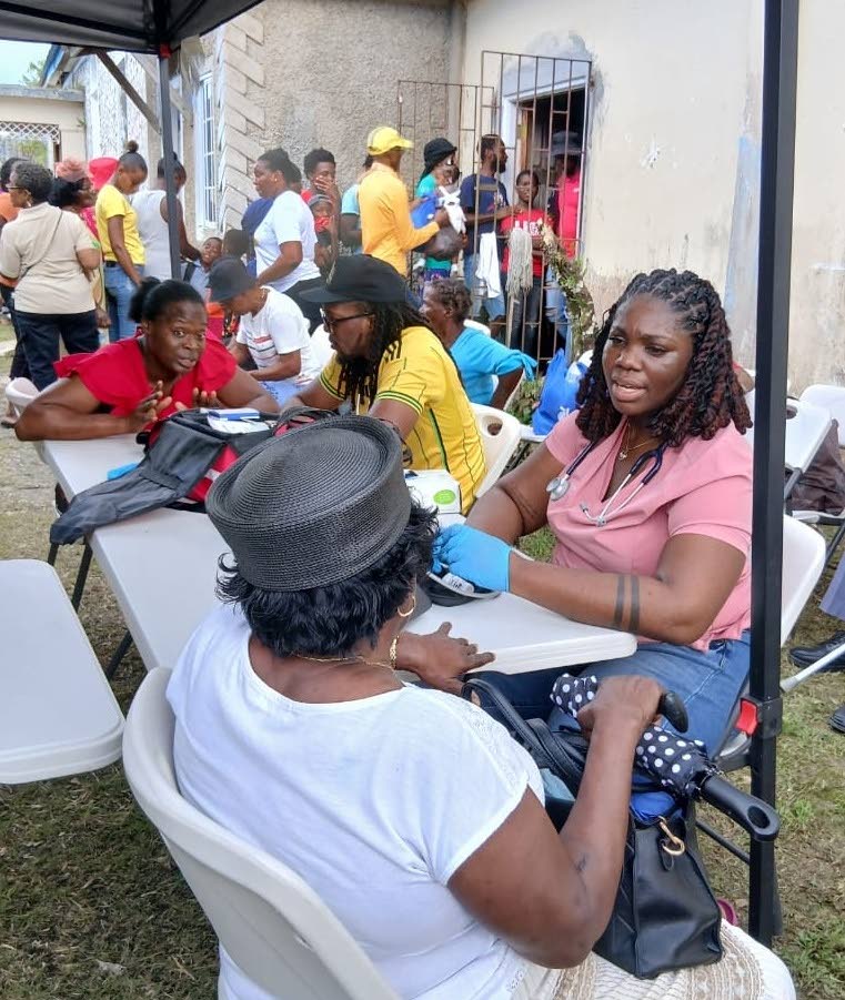 Dr Sydney Gray speaks with a patient during a recent medical mission in Askenish, Hanover.