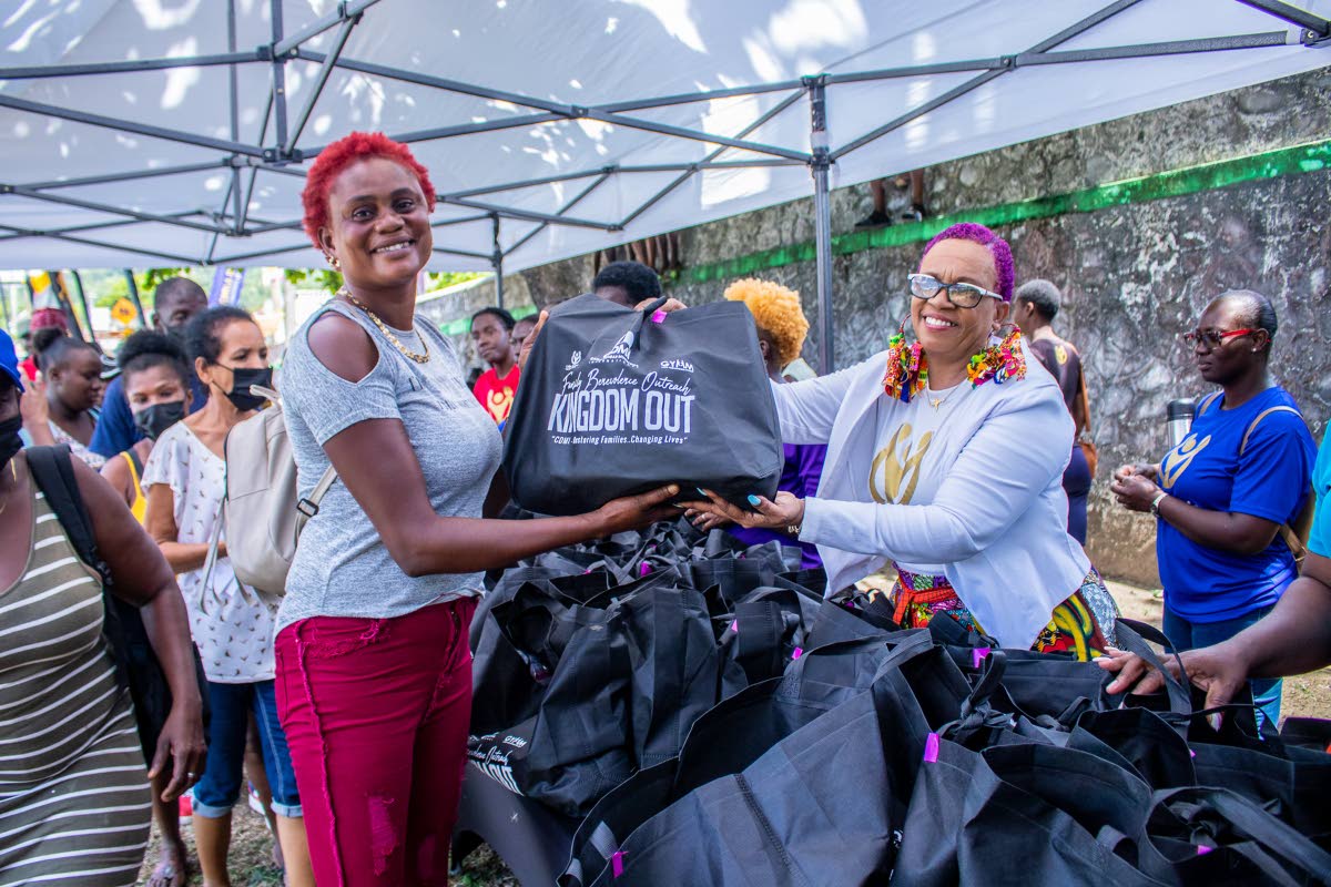 Bishop Dr Carla Dunbar, chief executive officer at Carla Dunbar Ministries International (right), distributing care packages to residents of Portland, at the organisation’s first Kingdom Out stop in 2022 at Lynch Park, Buff Bay, Portland. 