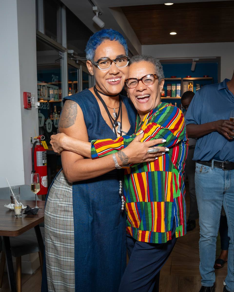 SiiM (left) shares a smile as media personality Fae Ellington warmly embraces her in celebration of her big moment.