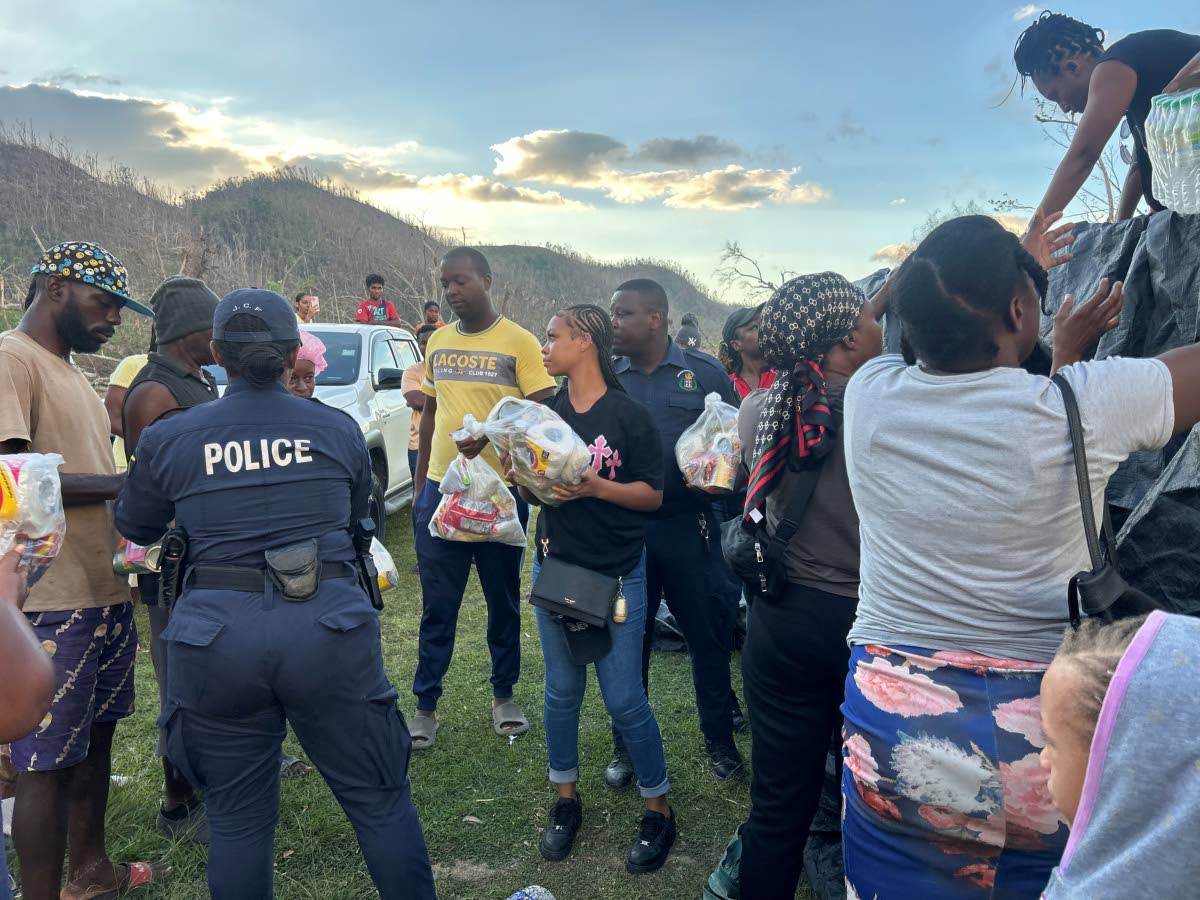 The team creates a chain to hand out food in an orderly fashion with the assistance of the police.