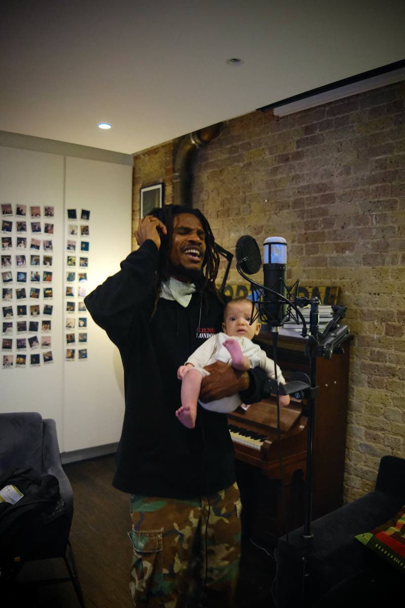 Shepherd cradles his infant son Ska during a recording session in June with music producer Toddla T at the latter’s studio in London.