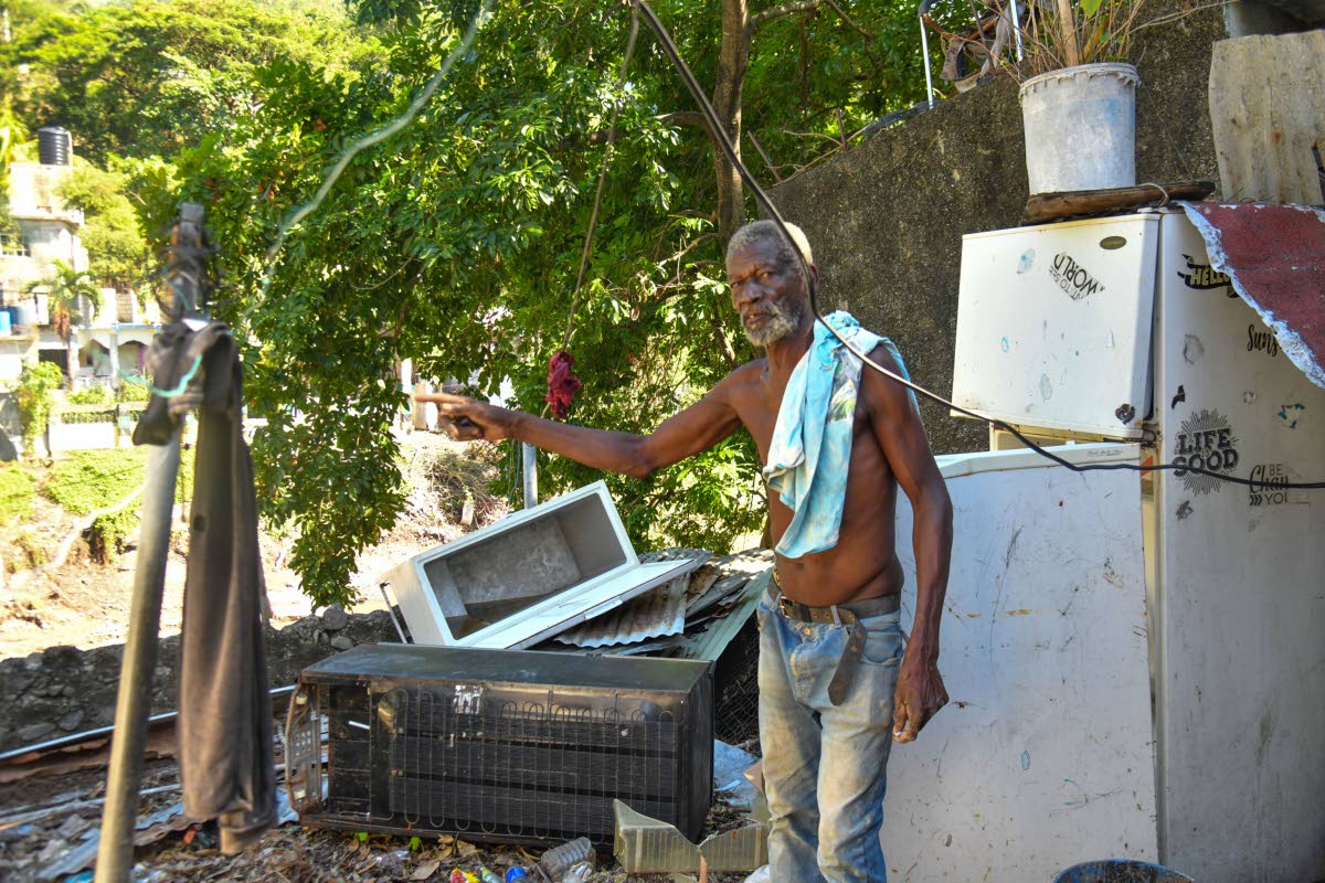 
Tavern resident Vernal  Crosdale, 68, gestures toward the eroding Hope River bank that threatens the stability of the home he has lived in for decades.