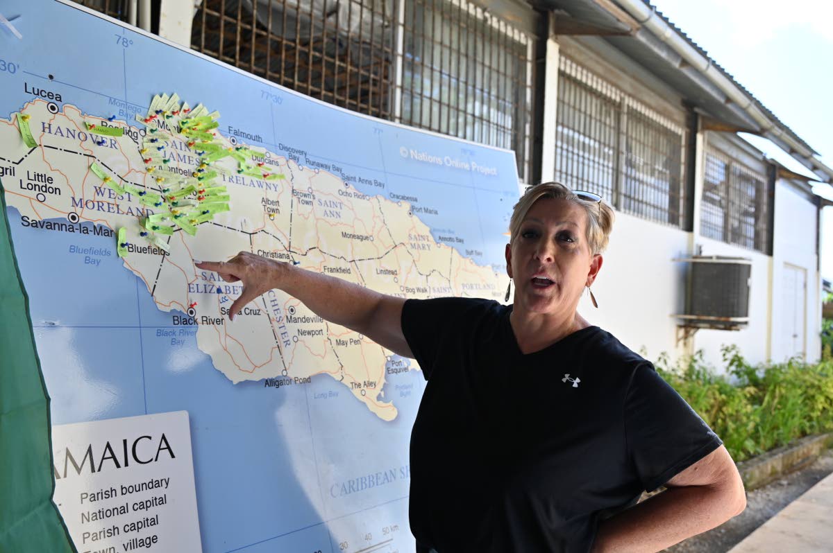 Pastor Mary Wildish gestures toward her colour-coded ‘survival map,’ tracking Operation Blessing’s relief efforts across affected communities in western Jamaica.