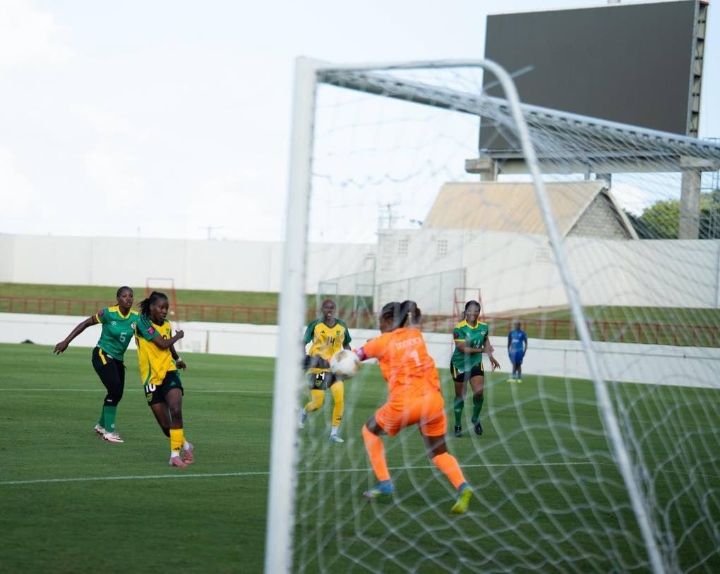 Reggae Girlz forward Jody Brown (second left) strikes to goal during a Concacaf W Qualifier at the Daren Sammy Cricket Ground yesterday.