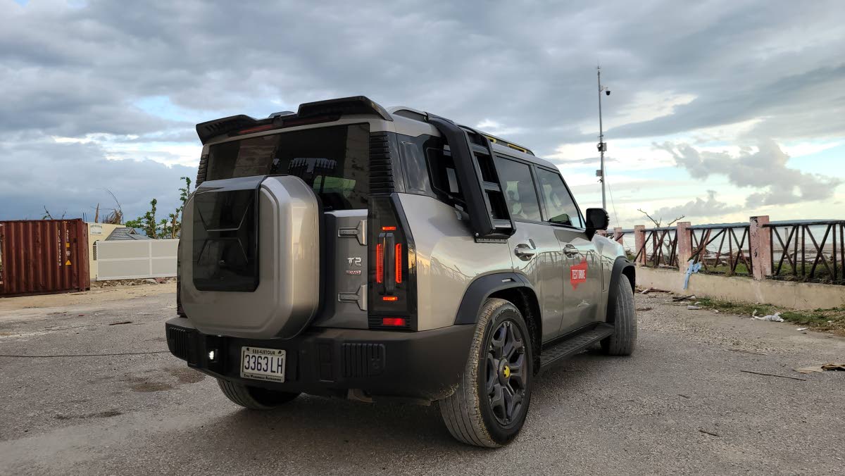 A three-quarter view emphasising the substantial ground clearance and the large alloy wheels, blending capability with modern aesthetics.