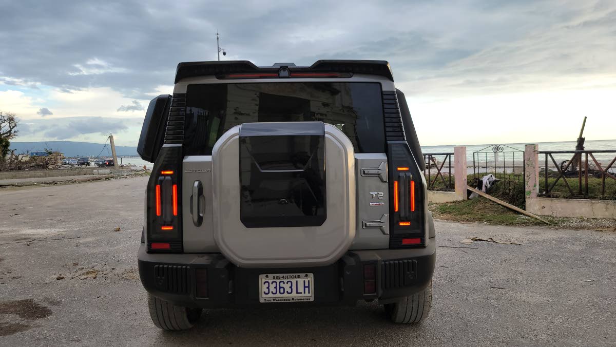 The imposing rear aspect featuring the externally mounted spare tyre and the geometric tail lamps for a signature off-road look.