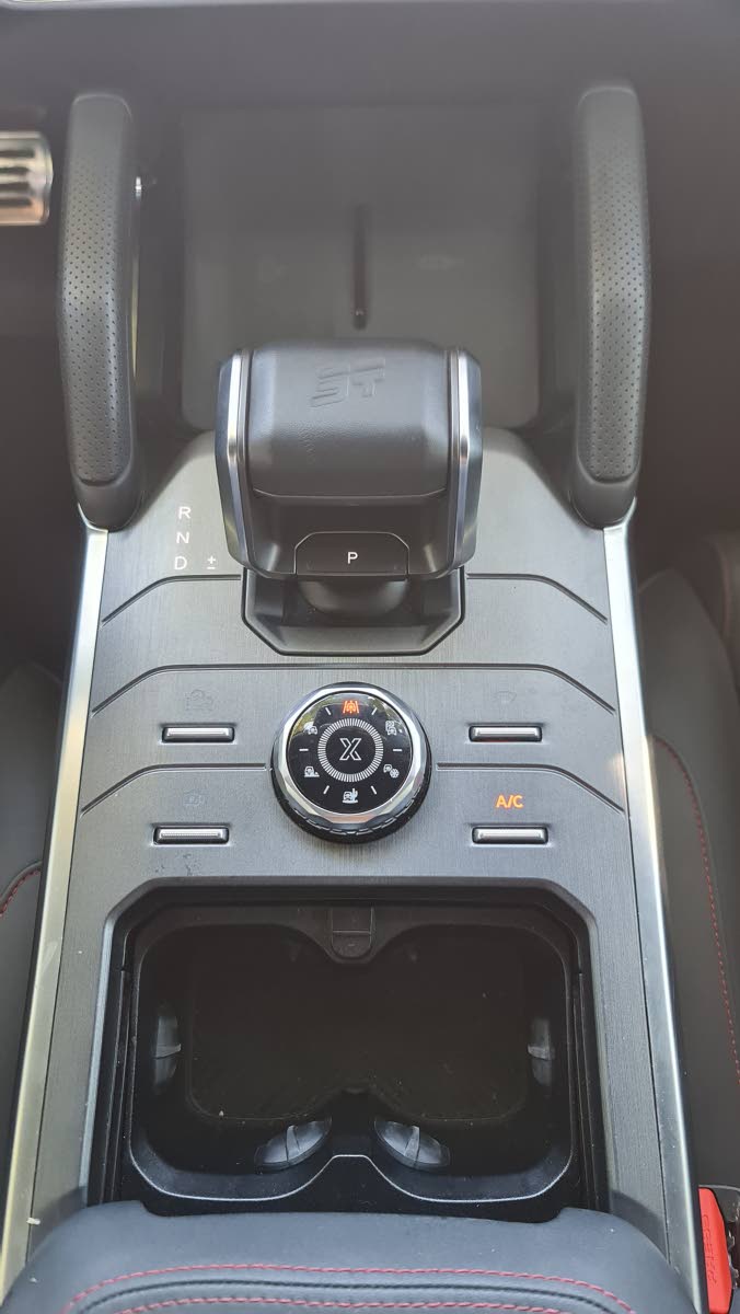 The robust central console area, featuring the tactile drive-mode selector dial and convenient surrounding controls.