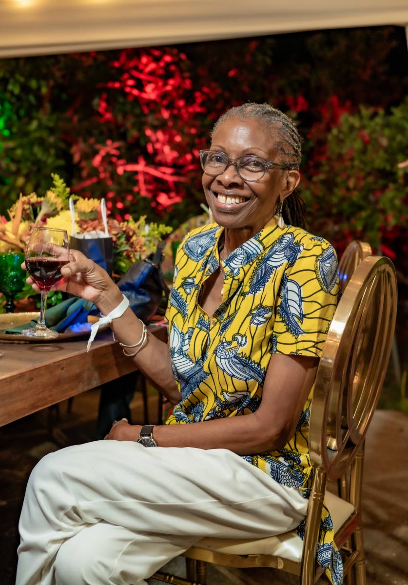 With a glass of red in hand, Norma Messam raises a toast to the birthday girl.