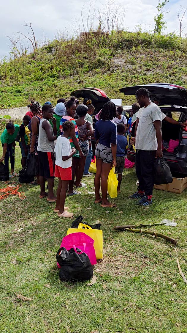 Residents of Giddy Hall, St Elizabeth receive care packages from Give Back Jamaica following Hurricane Melissa.