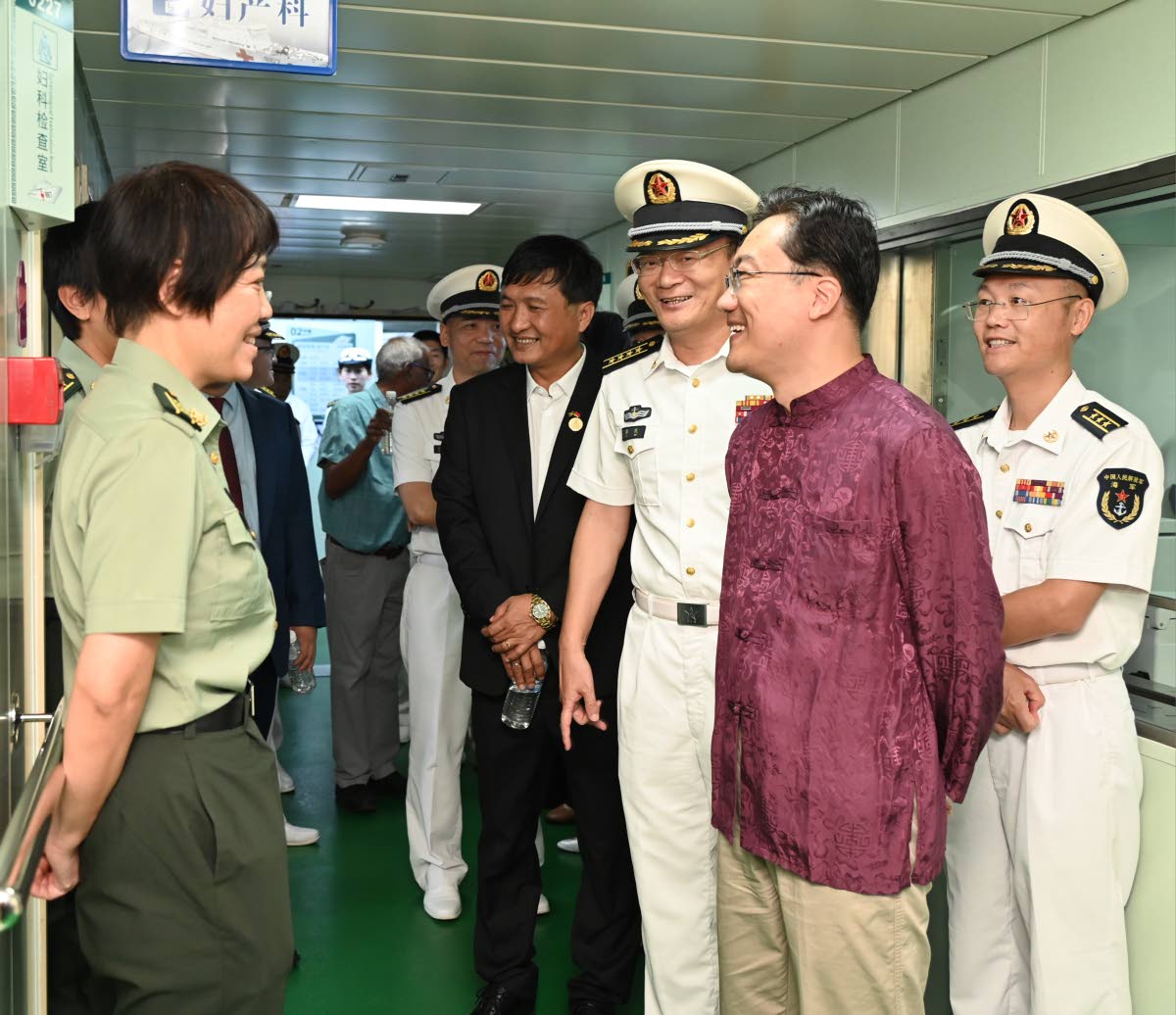 Ambassador of the People’s Republic of China to Jamaica, Wang Jinfeng (second right), greets crew members of the ‘Ark Silk Road; medical ship at the Montego Bay Cruise Ship Terminal on Thursday.