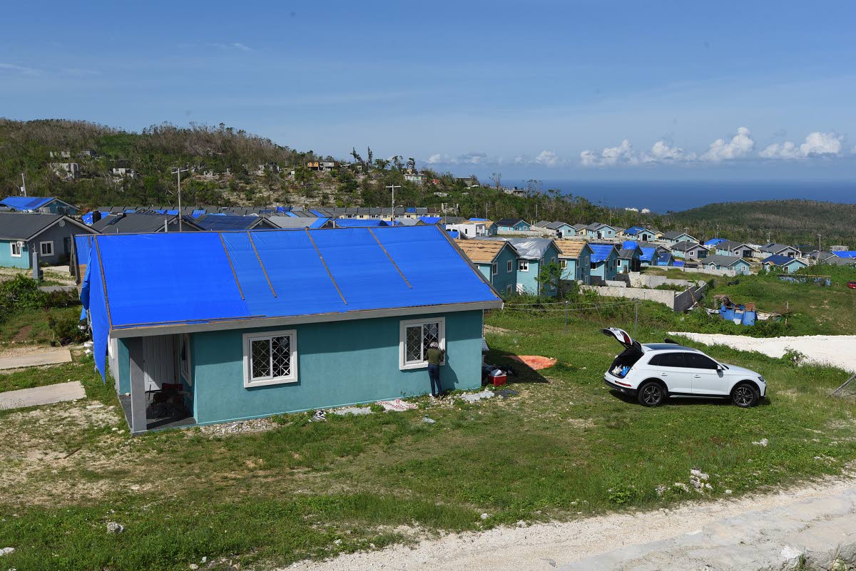 Several Edmund Ridge Estate homes with tarpaulins on the roofs.