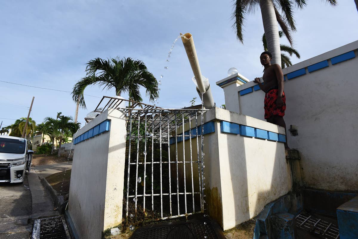 Water trickles from pipes chanelling water from a spring inside Leopold Fogo’s yard in Ironshore, Montego Bay, St James.