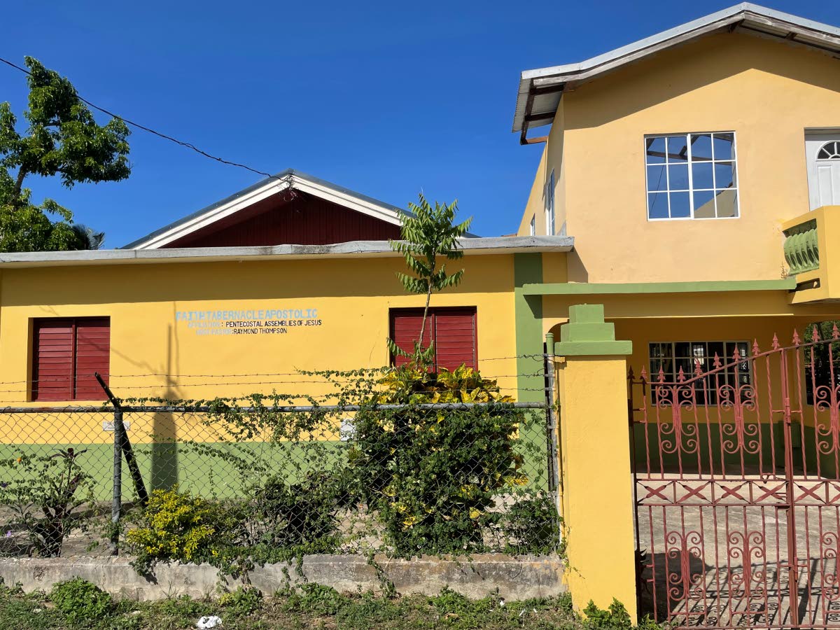 The Faith Tabernacle Apostolic Pentecostal Assemblies of Jesus with its damaged roof.