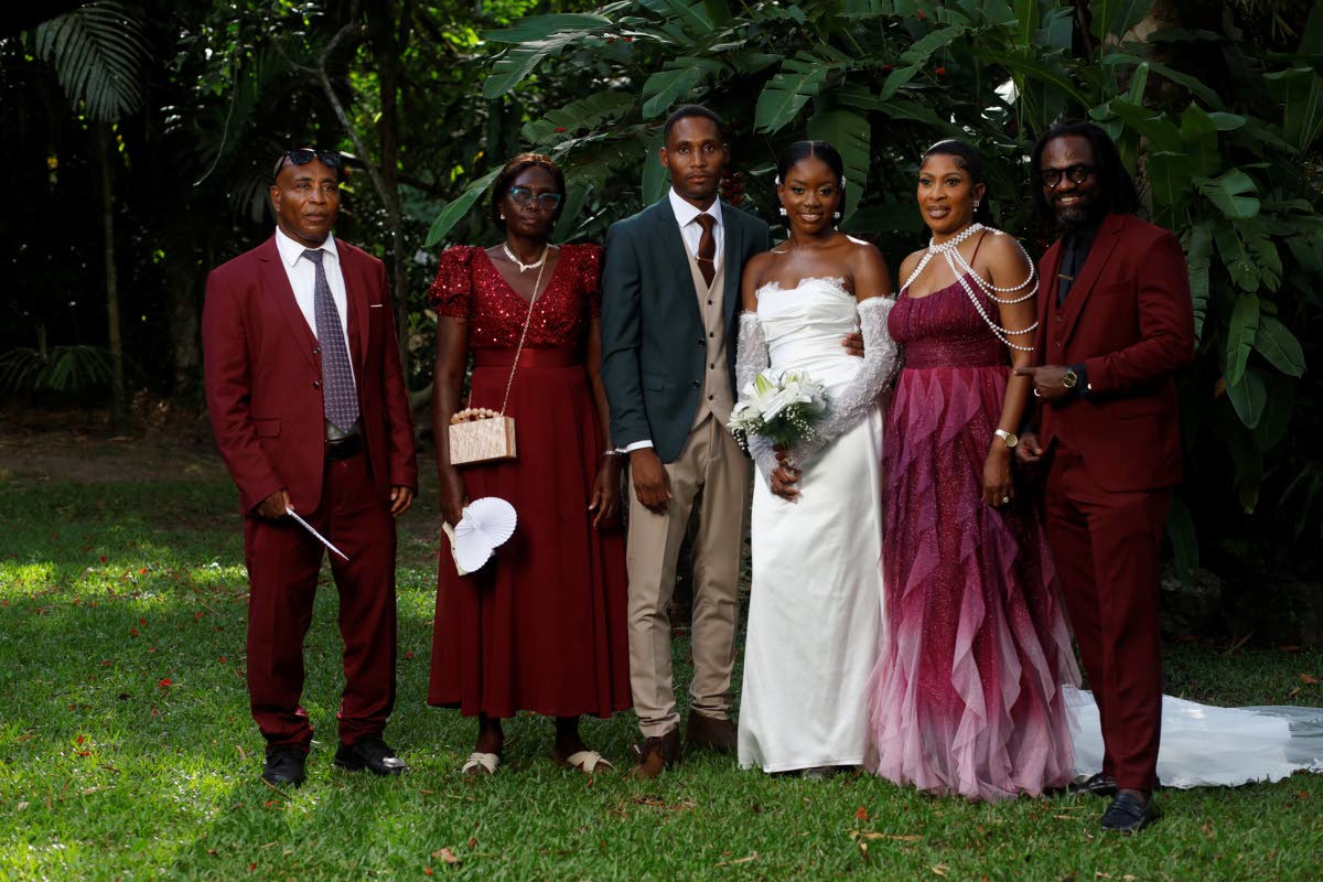 The newly married couple pose with their parents. From left: the groom’s parents Evard Layne, Dawnette Parker and the bride’s parents Charmaine and Steve McDonald.
