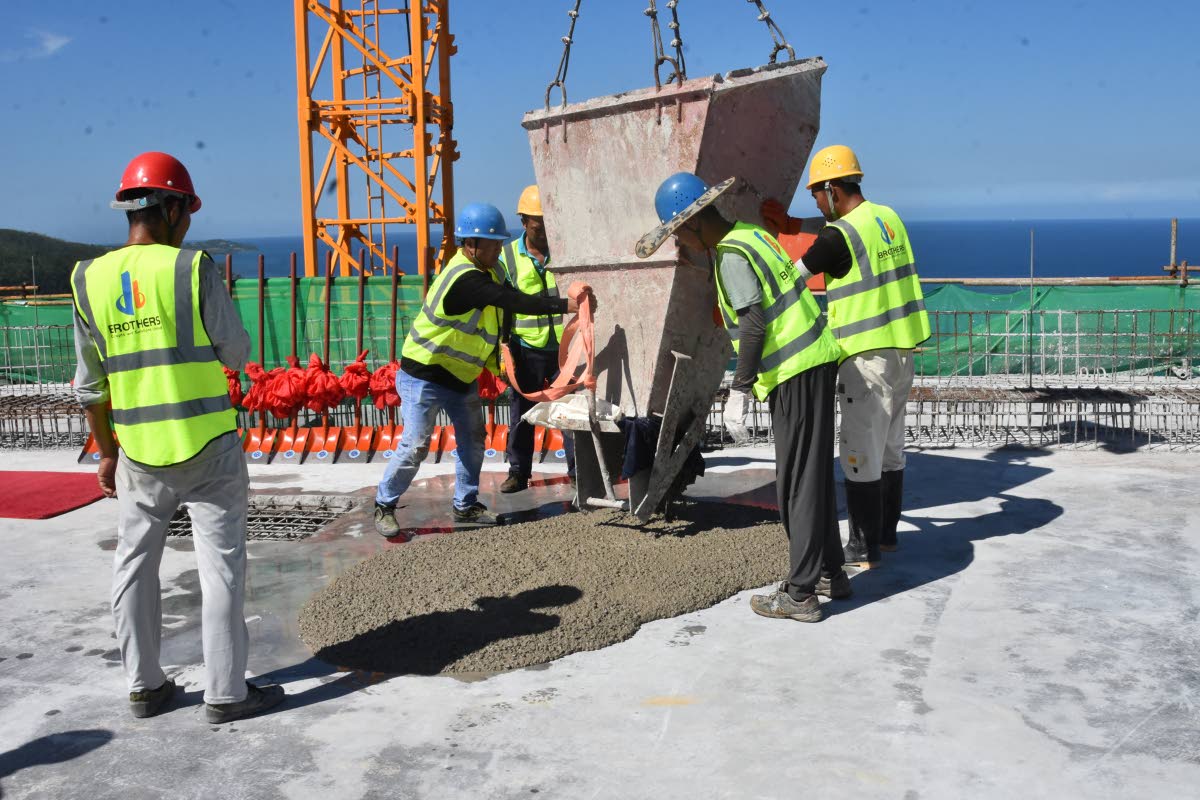 Workmen get ready to pour concrete in preparation for the topping out ceremony for Tower One at The Pinnacle Montego Bay.