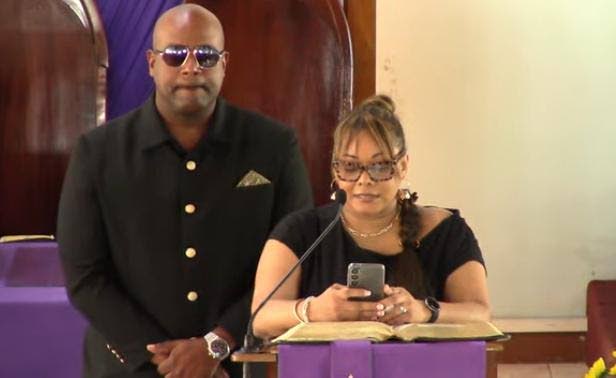 Dwight Crawford, deputy mayor of Montego Bay and councillor for the Spring Garden Division in the St James Municipal Corporation, and his sister Kimika Crawford, present tributes during the thanksgiving service for their father, businessman Ruel Alphanso C