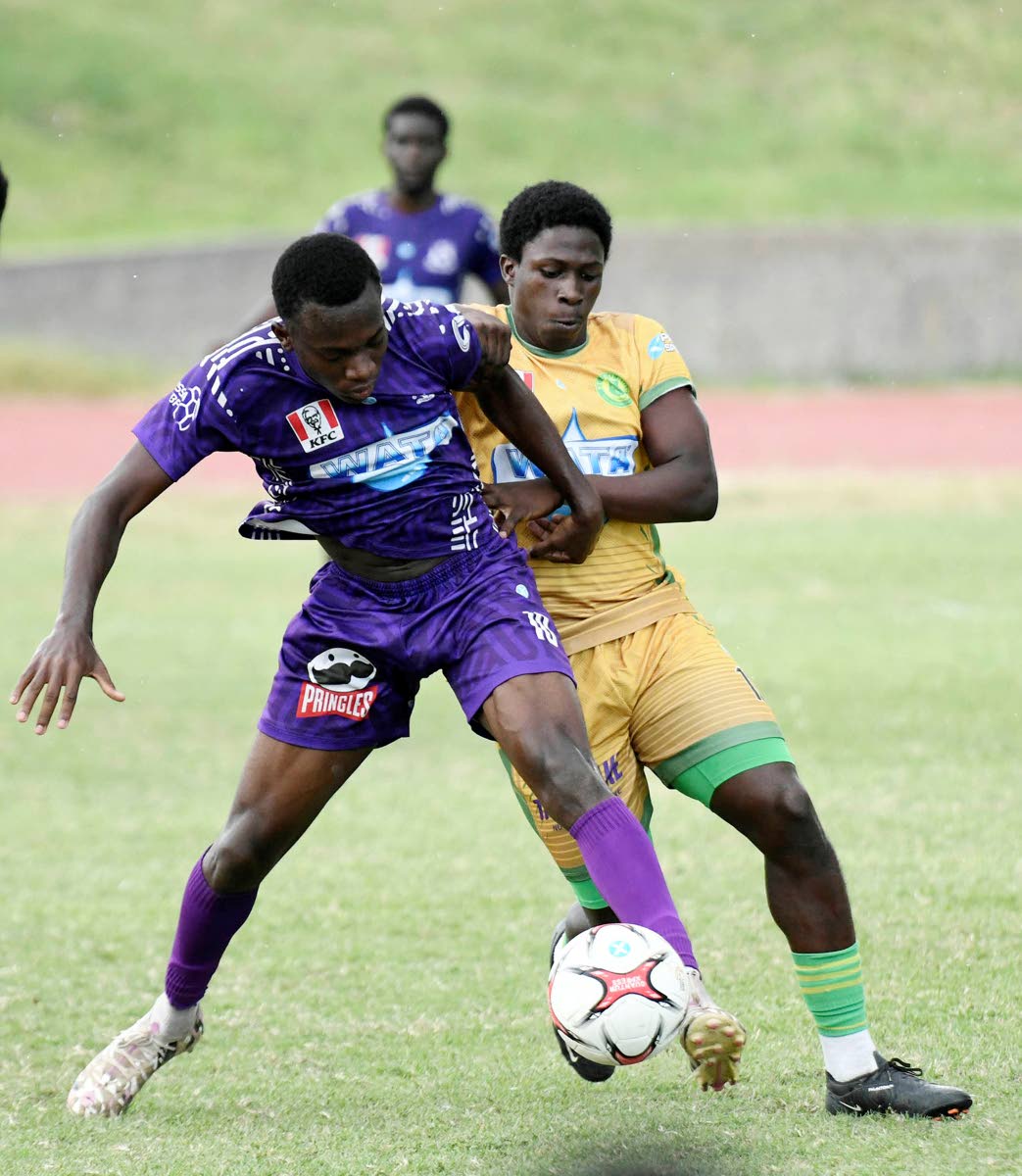 Kingston College’s Kamaul Patterson (left) shields the ball from Richardo Lewis of St Jago High School during the Walker Cup KO match at Stadium East yesterday. KC won the encounter 4-1.