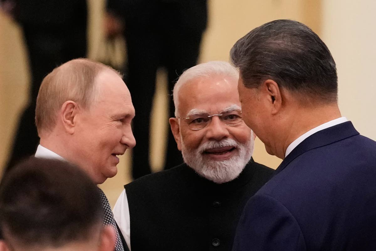 
From left: President of Russia Vladimir Putin, Prime Minister of India Narendra Modi, and President of China Xi Jinping talk ahead of the Shanghai Cooperation Organisation  summit at the Meijiang Convention and Exhibition Center in Tianjin, China, on Mond