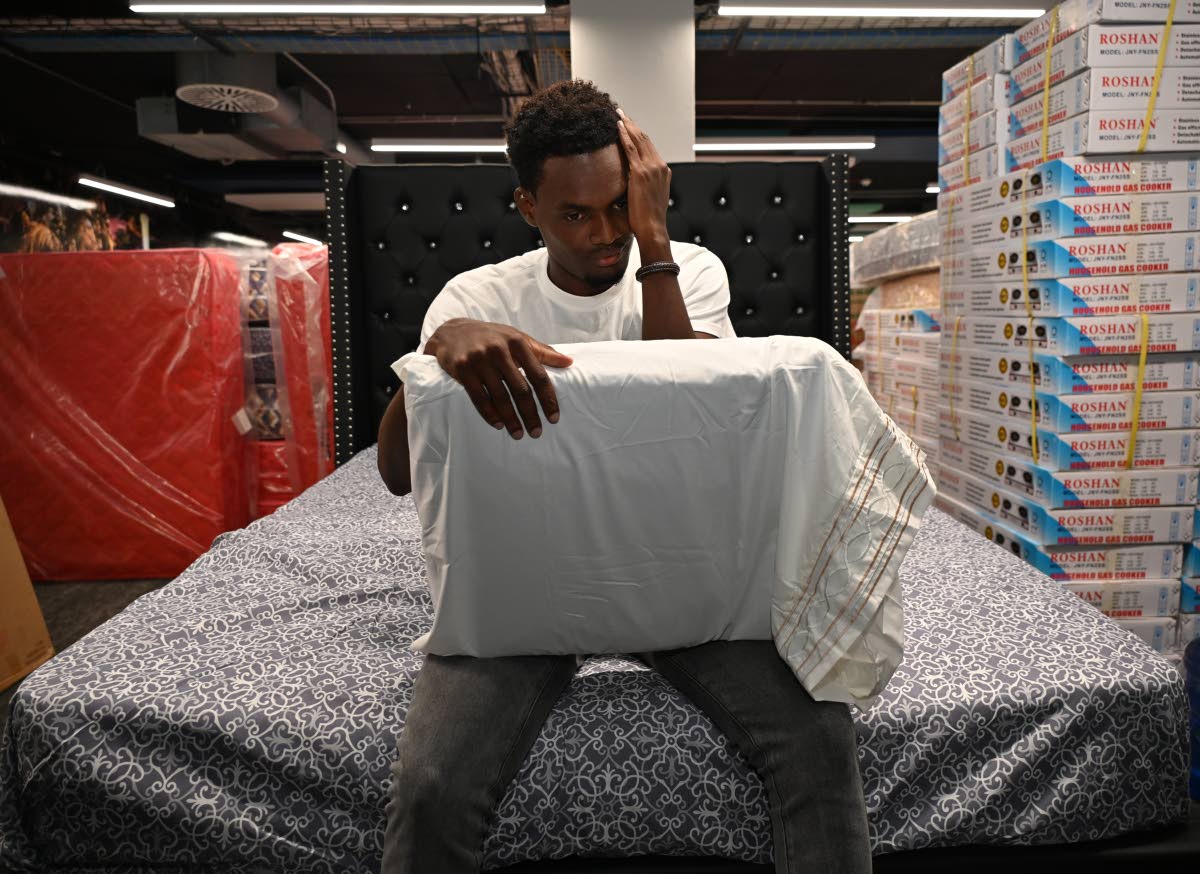 Dellon Hall, an employee of Strobe Etech Communications, is overcome with emotion after receiving a bed during the company’s handover of essential household items to staff affected by Hurricane Melissa on Tuesday.