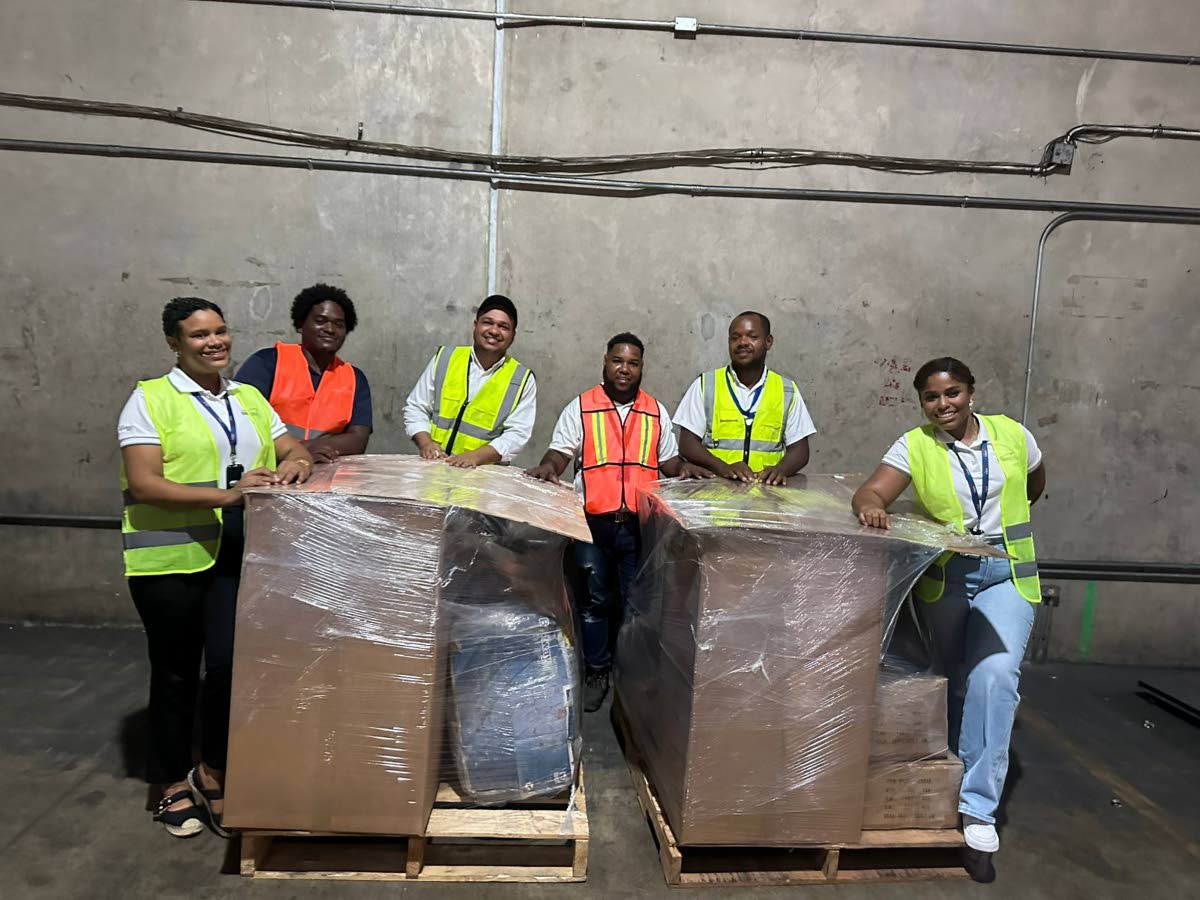 Team members from Pier 17 Group Dominicana are pictured with a humanitarian shipment prepared for Jamaica in support of national recovery efforts following Hurricane Melissa. The consignment, estimated to arrive in Kingston on December 19, includes potable