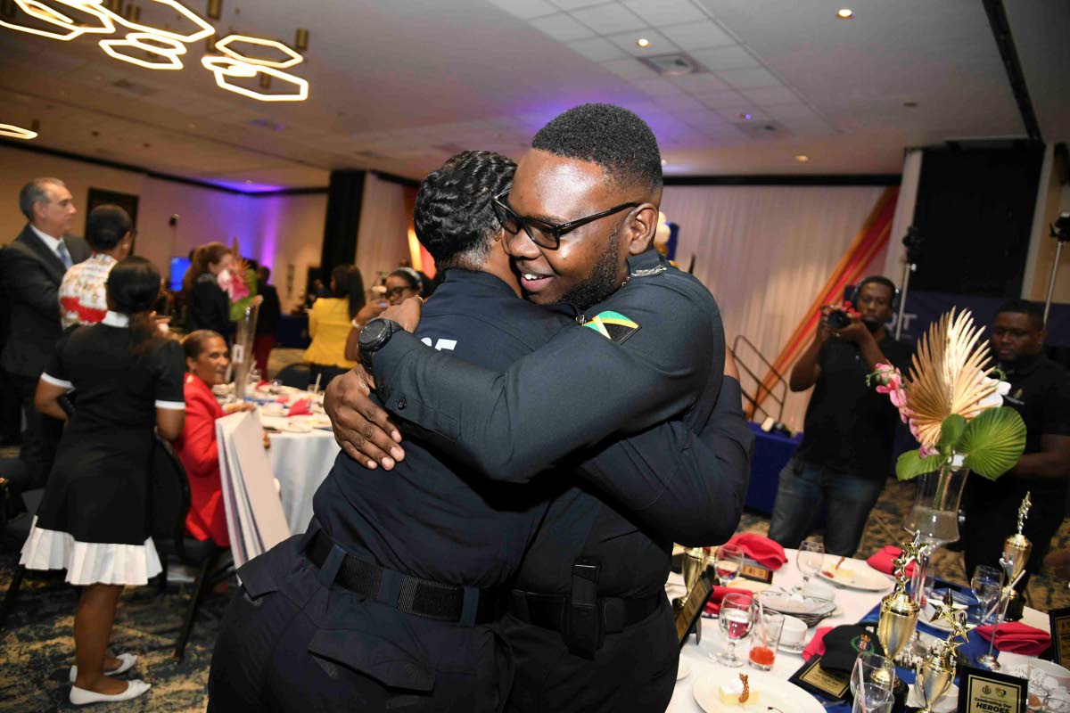 Shantel Powell (left), winner of the 2025 top cop award, is embraced by Corporal Rojehn Holt, first runner-up, during the Lasco Chin Foundation/Jamaica Constabulary Force Saluting Our Heroes Awards ceremony held yesterday at The Jamaica Pegasus hotel in Ne