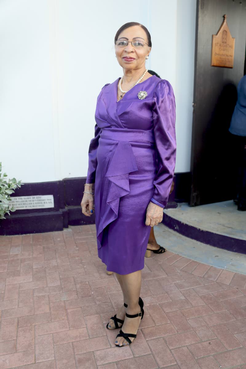 Beverley Phillips embraces purple in a faux-wrap, knee-length dress.