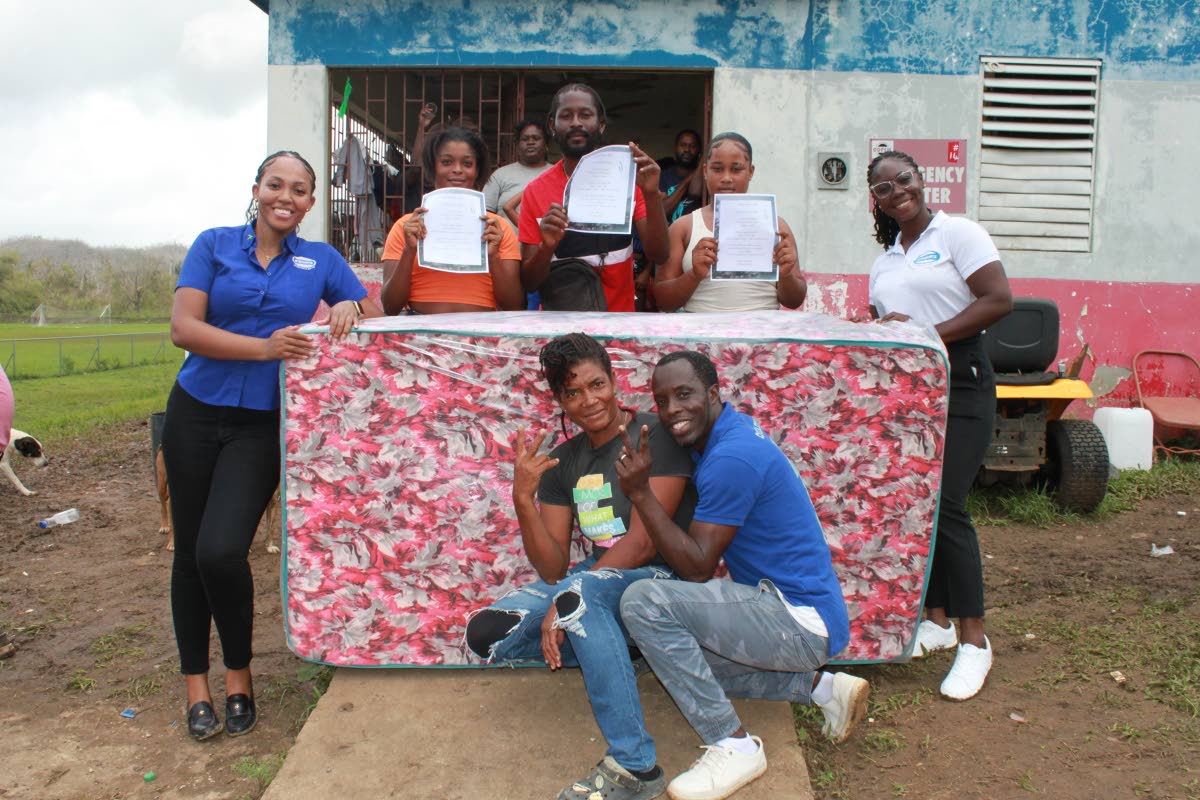 Survivors of Hurricane Melissa in Westmoreland proudly display their new mattresses donated through the “Beds for Jamaica” project, an initiative started by U.S.-based 9th-grader Zoraida de Souza. Stewart’s Automotive Group supported the effort by de