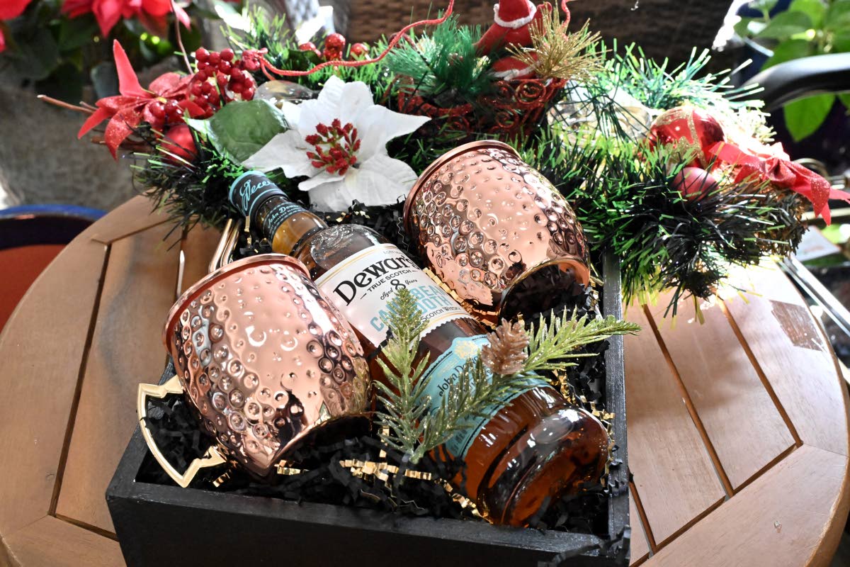 Giftable pieces like Dewar’s whisky and festive mugs double as décor.