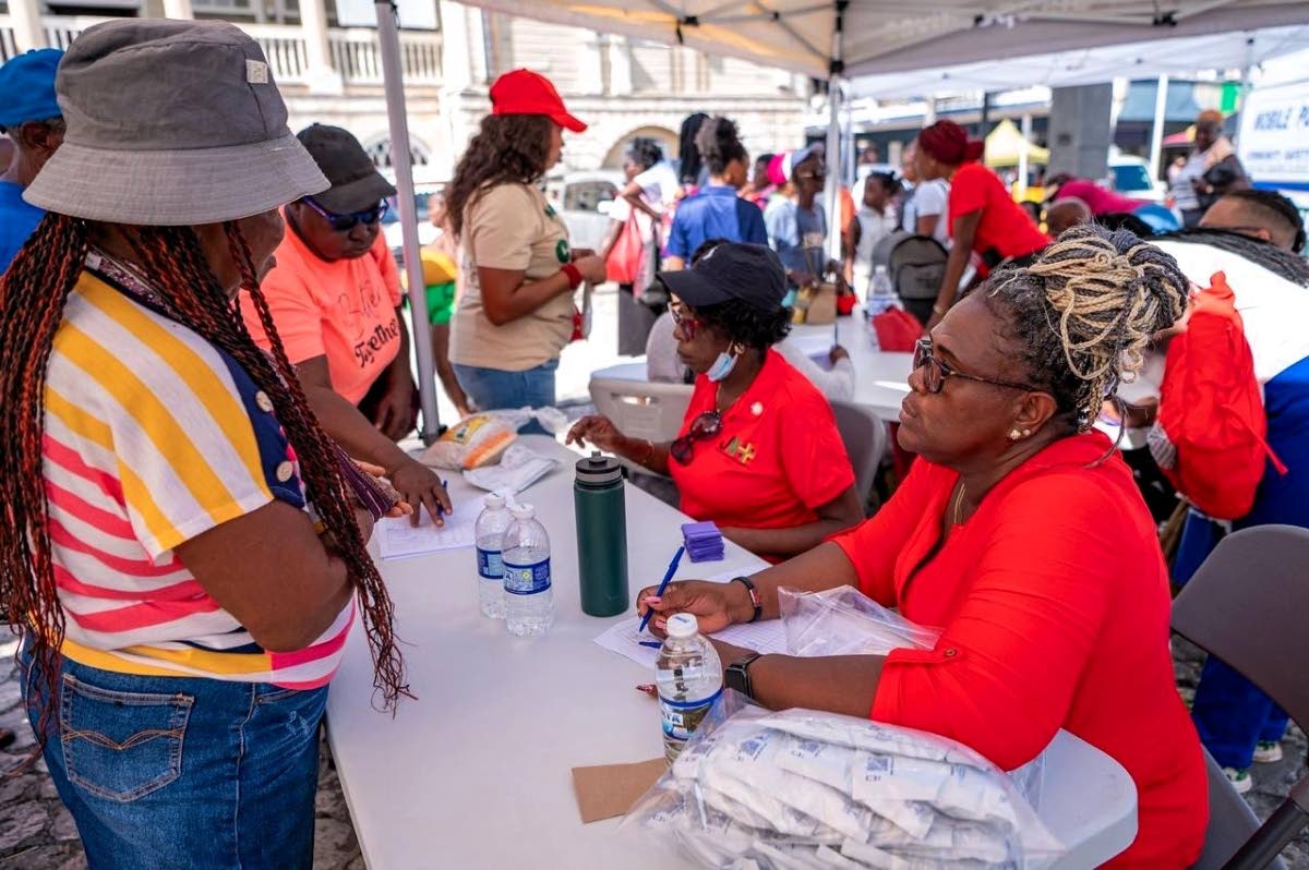 JN+ staff members attend to people at their health camp.