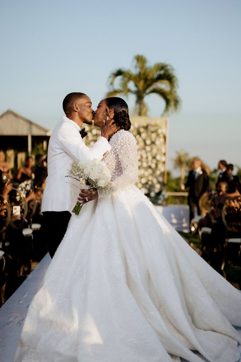 Following the official announcement of husband and wife, the bride and groom seal their love by sharing a beautiful kiss.