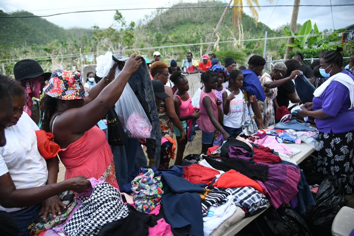 Residents of Shrewsbury search through clothes being provided to them by Faith Chapel of Faith Apostolic Ministries Health and Wellness Department on December 13 at the Mother Lewis AME Church in Shrewsbury, Westmoreland. 