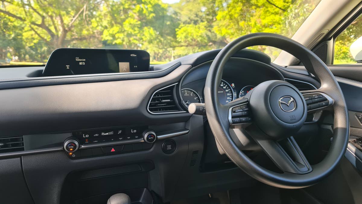 The centre console showcases the ergonomic layout, dominated by the non-touch infotainment screen positioned optimally for quick, safe glances while driving.