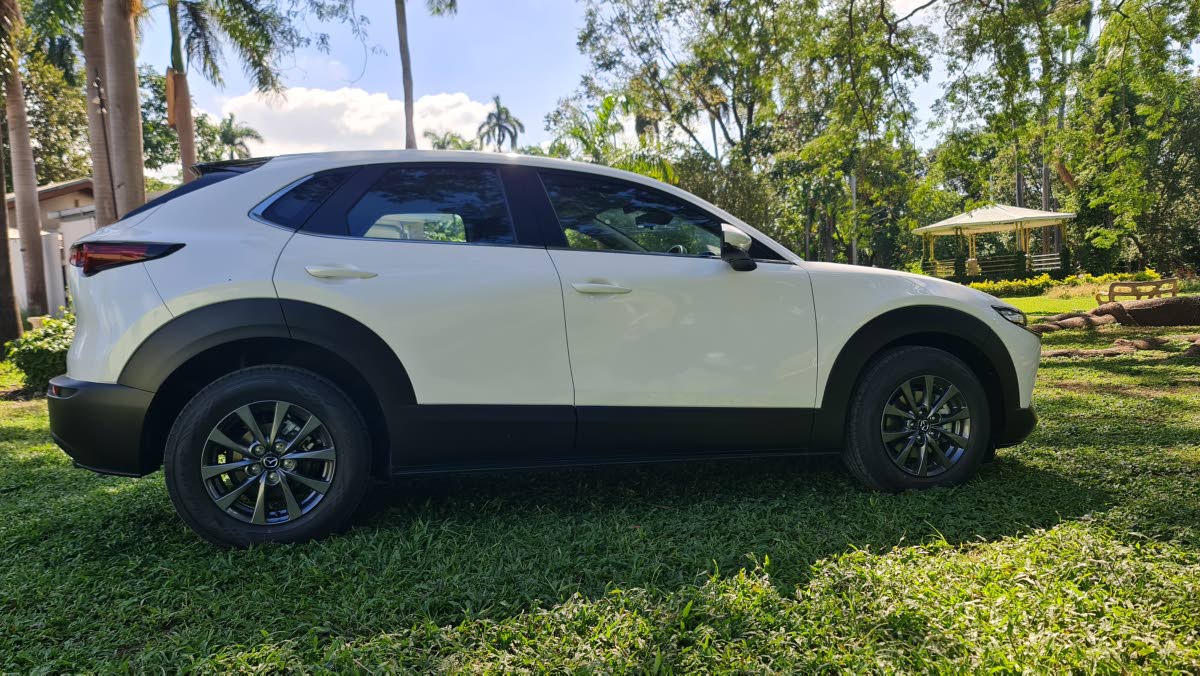 Examining the profile reveals the vehicle’s sophisticated surface treatment and subtle panel curvature, contrasting nicely with the utility-focused protective body cladding.