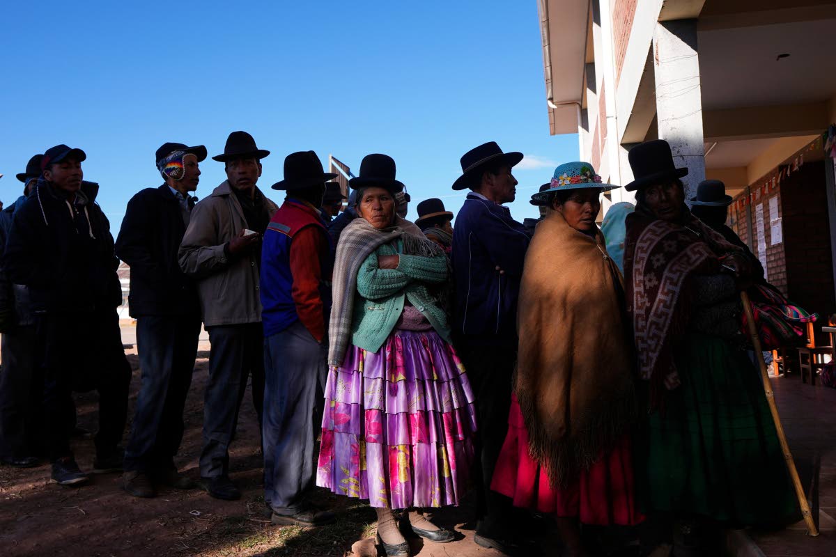 Voters stand in line at a polling station during general elections in Jesús de Machaca, Bolivia.