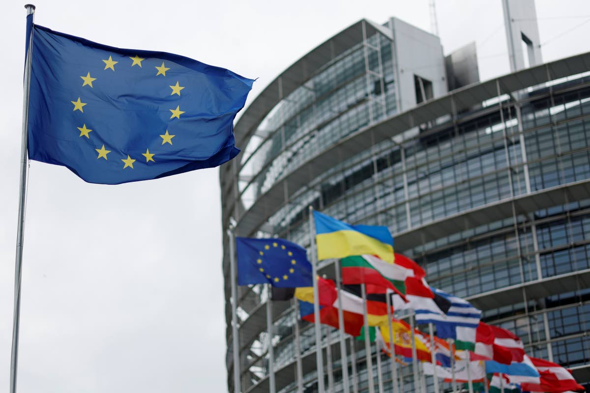 The European flag, left, flies at the European Parliament in Strasbourg, eastern France.