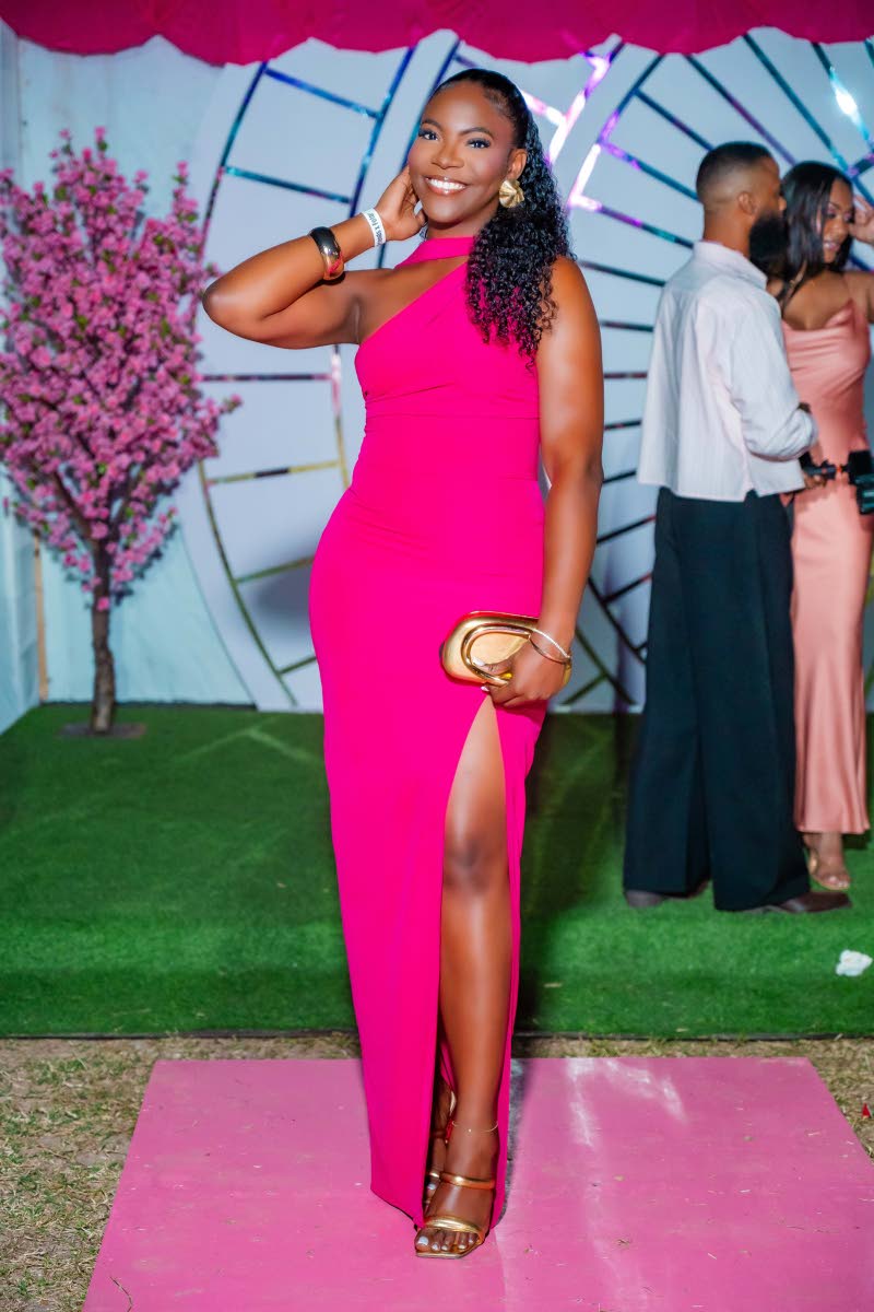 Valuation surveyor Jhunelle Thompson makes the moment hers in a daring high-slit dress. 