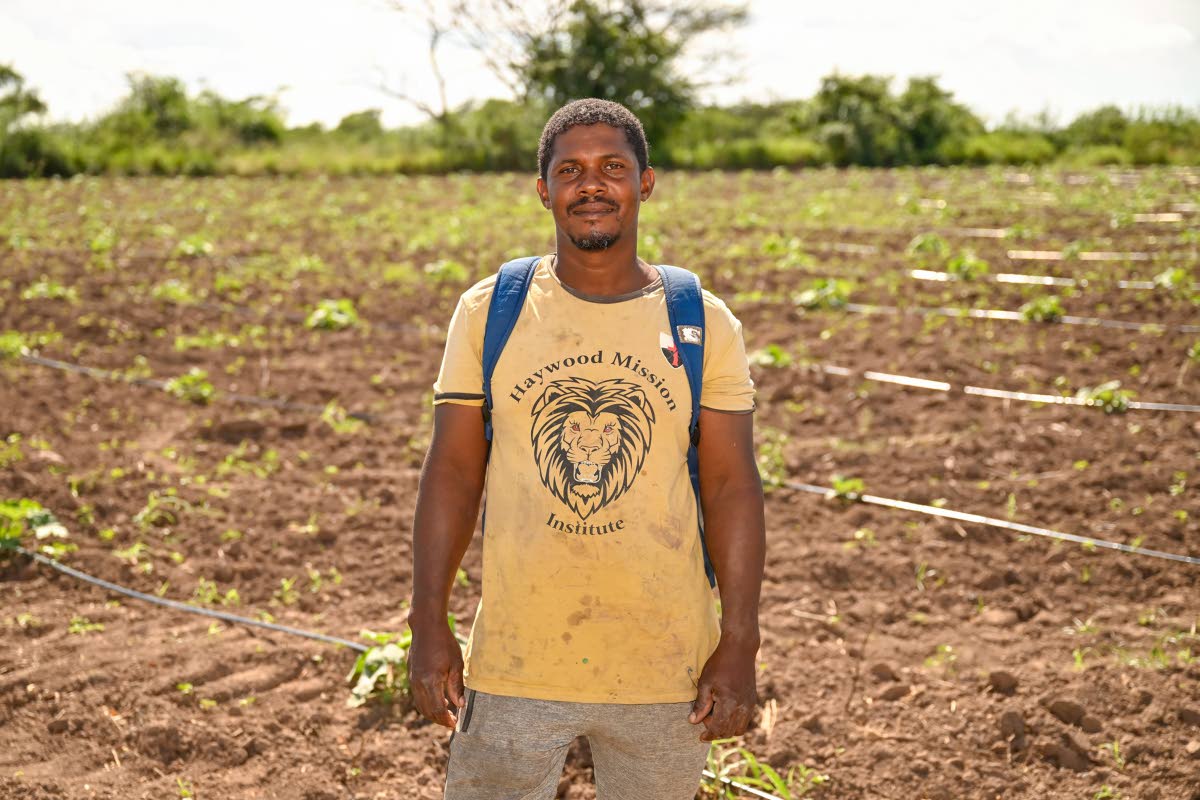 Kenneth Robinson takes a moment from working on his farm.