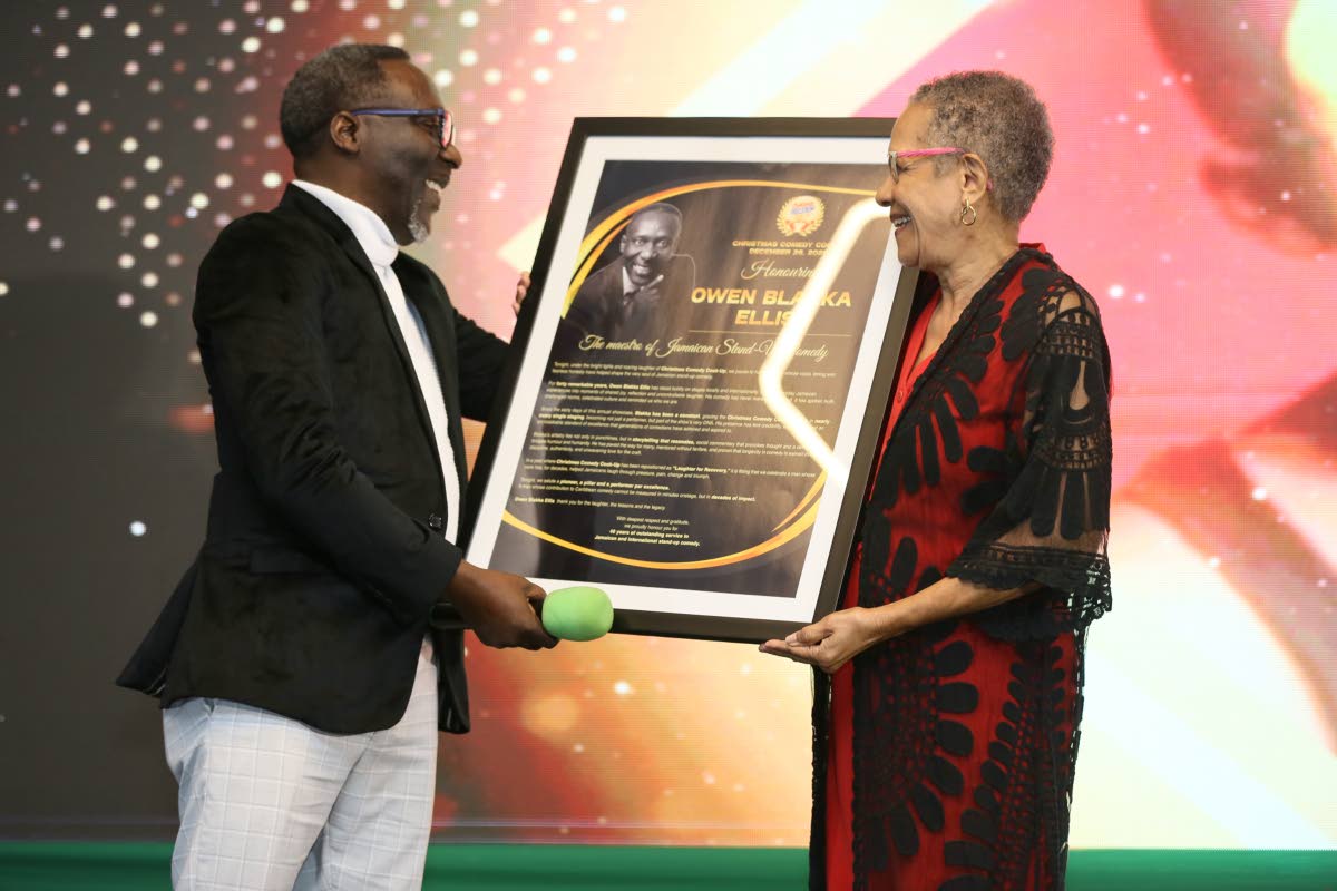 Fae Ellington (right) presents a citation to Owen ‘Blakka’ Ellis, in recognition of his contribution to comedy.