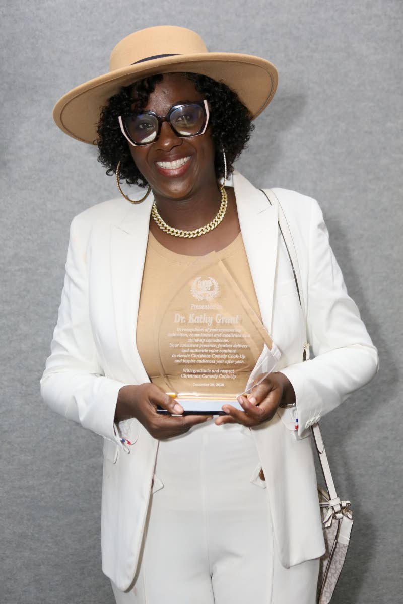 Dr Kathy Grant proudly displays her award, marking her long-standing contribution to the show.