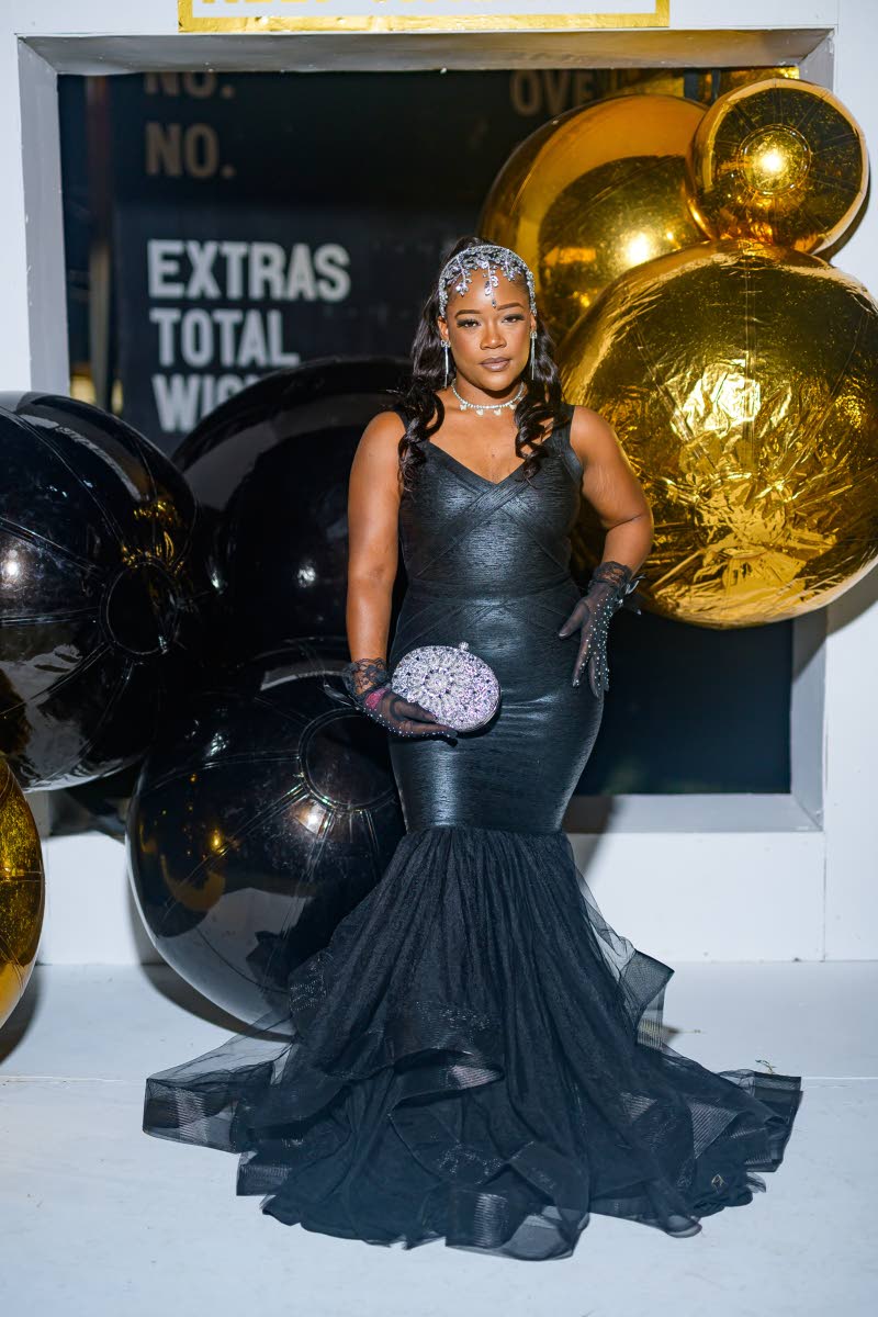 Tatiana Robertson, marketing officer, shows up in a black mermaid dress for the occasion.